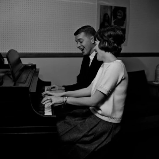 Young couple playing piano and singing Poster Print (18 x 24)