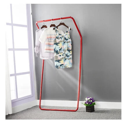 Display stand. Colorful floor against the wall. Hanger. Clothing. Clothes tree.