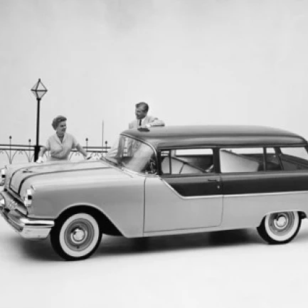 Man and woman standing near Pontiac Chieftain 860 Station Wagon Poster Print (24 x 36)