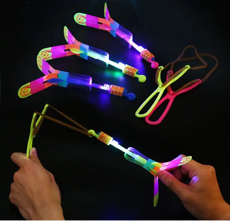 

200Pcs/lot Amazing LED Light Arrow Rocket Helicopter Rotating Flying Toys Party Fun Kids Outdoor Flashing Toy Color Random