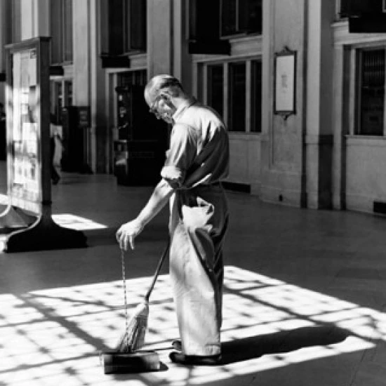 Senior man sweeping a floor Poster Print (18 x 24)