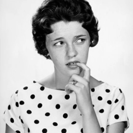 Close-up of a young woman biting her nails Poster Print (18 x 24)