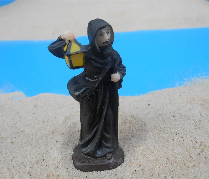 

Mental sand sandbox game with Sandplay psychological product class character Priest holding a lantern
