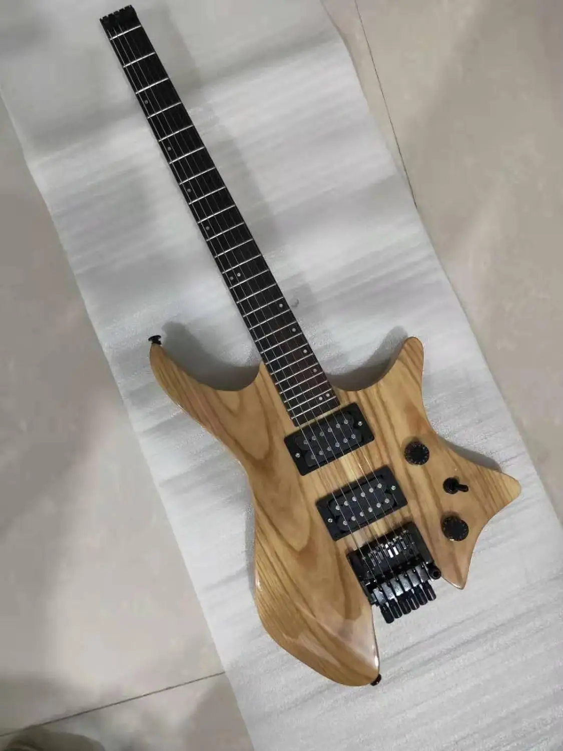 

New custom 6 string headless electric guitar, white wax wood color, double swing bridge,