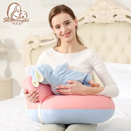 baby holding pillow