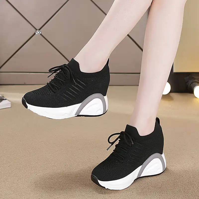 white sneakers with black heel