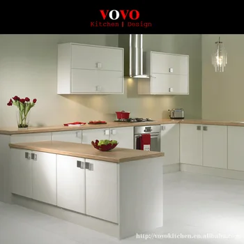 

U shaped white kitchen furniture with solid wood bench top