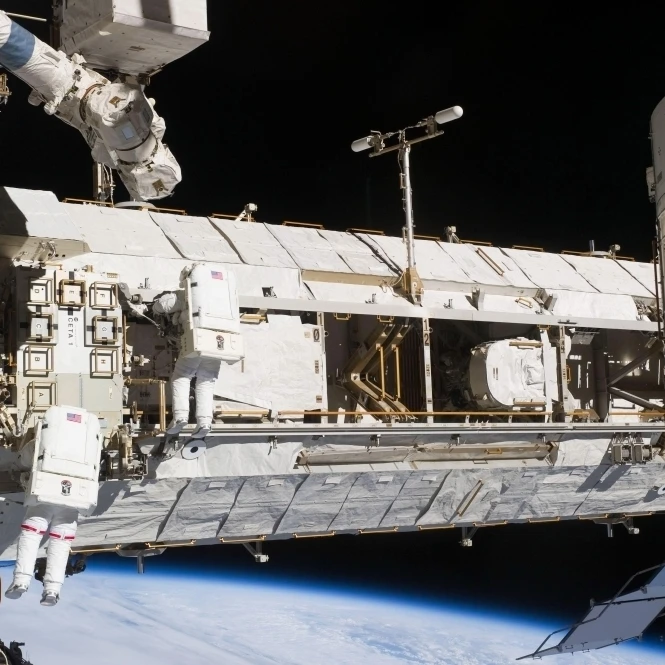 Astronauts continue maintenance activities outside the International Space Station Poster Print (34 x 22)