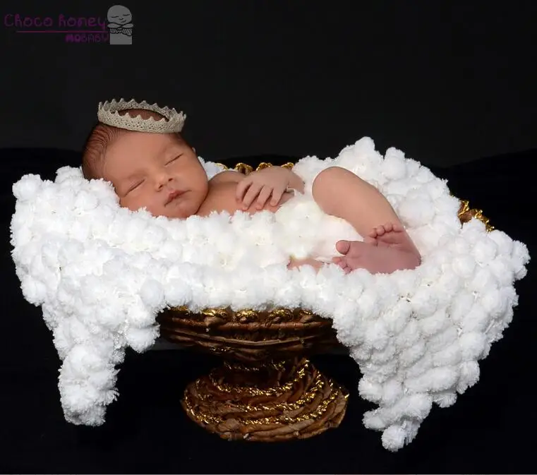 white pom pom baby blanket