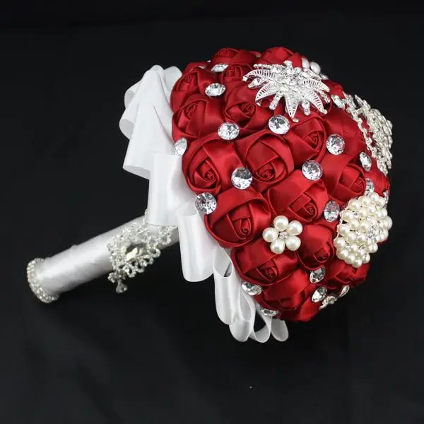 crimson bride holding flowers decorated with pearls diamond ribbon