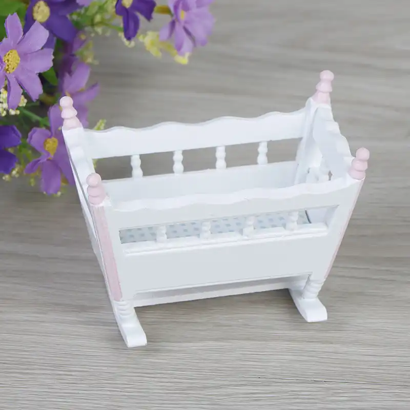 white wooden cradle