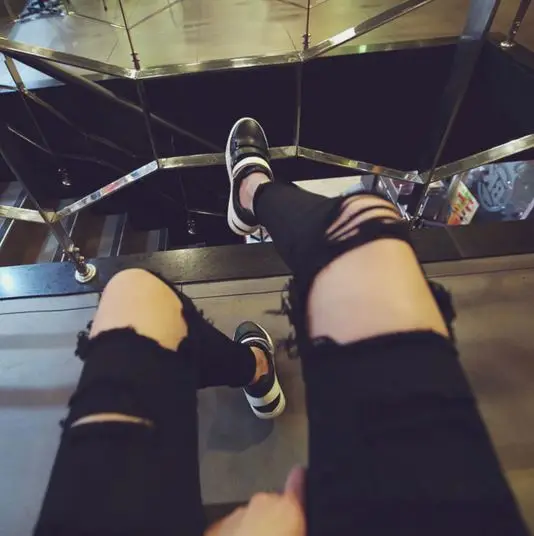 black jeans with holes in them