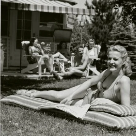Young woman sunbathing in the backyard Poster Print (18 x 24)