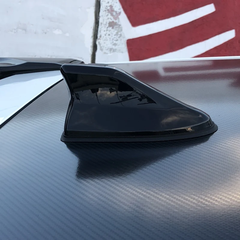 Silver stick on car aerial shark fin