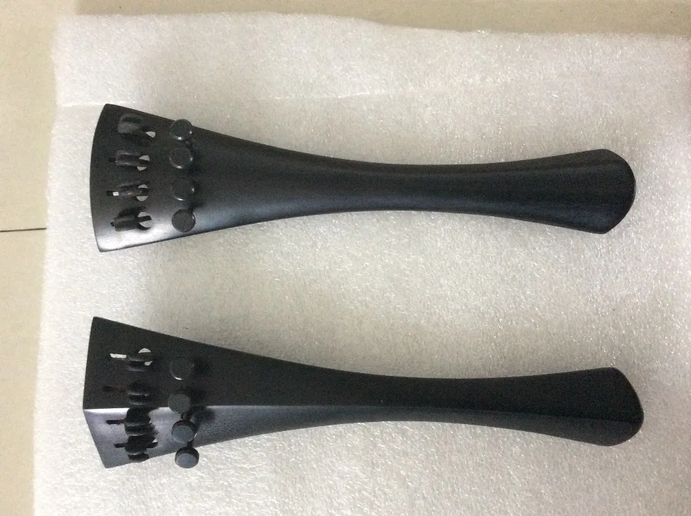 

Two pieces of 4/4 size ebony cello tailpieces round and hill model