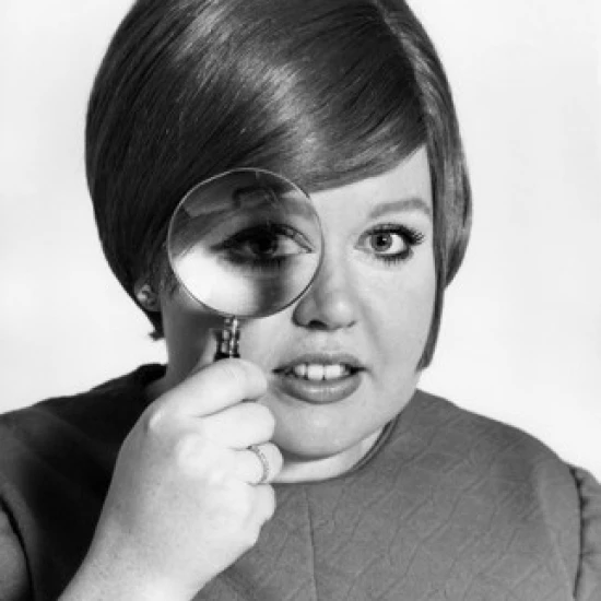 Studio portrait of teenage girl looking through magnifying glass Poster Print (18 x 24)
