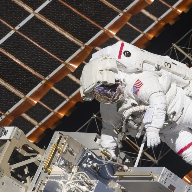 Astronaut working on part of the International Space Station Poster Print (17 x 11)