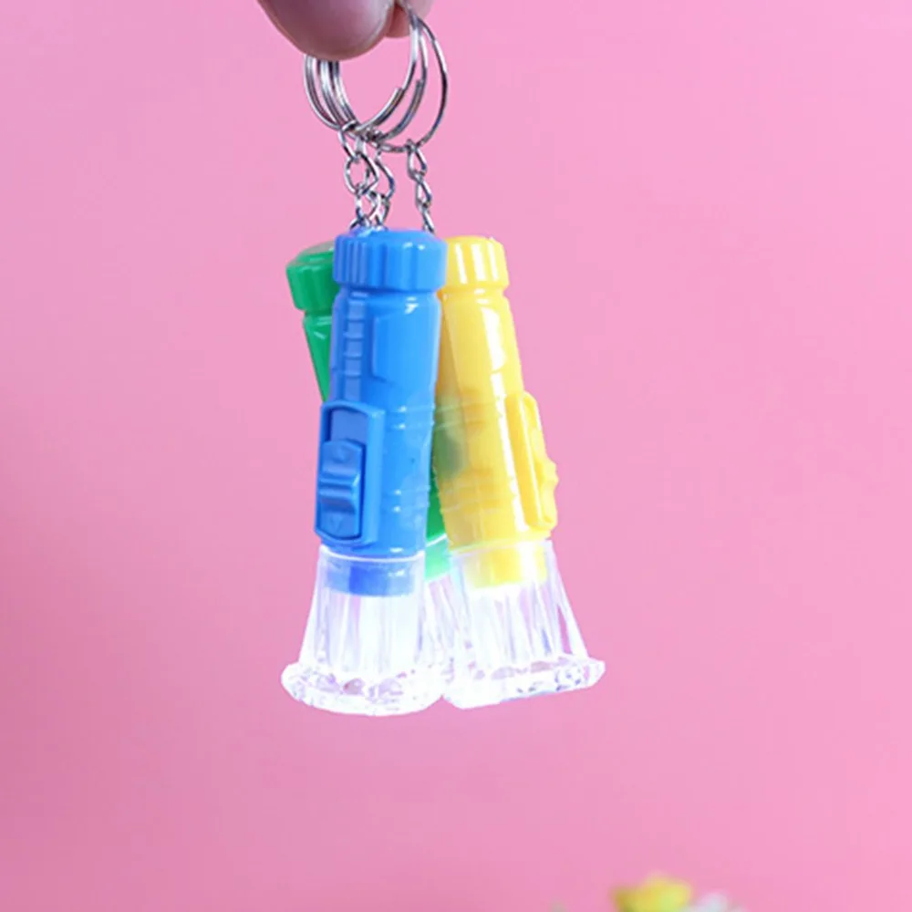 

Mini LED Flashlight Plastic Hand Torch Portable Keyring Super Bright Button Cell Powered Flash Light (Random Color)