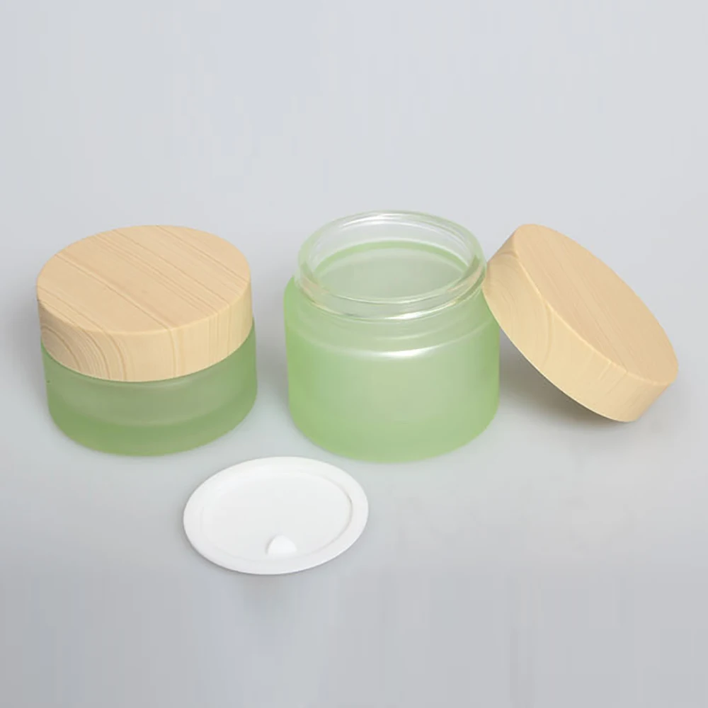 

Shape round Green bottle 30g glass and yellow wood cover for cream jar, 1 ounce make up packaging in stock