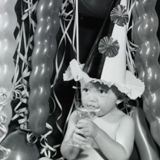 Close-up of a baby boy sipping champagne from a glass Poster Print (18 x 24)