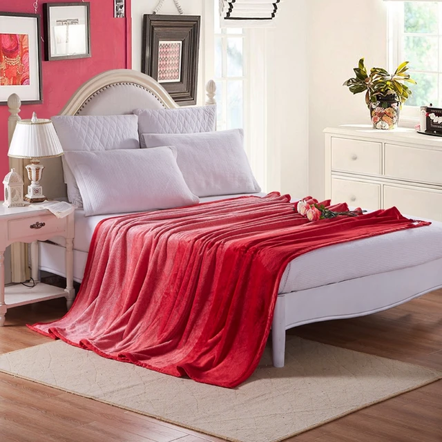 Red solid color fleece blanket on the bed,100 polyester flannel bed