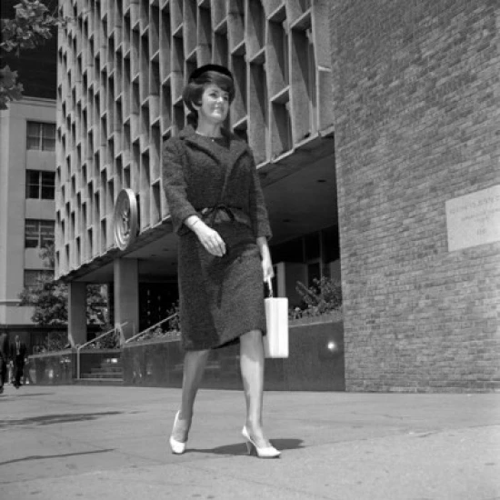 Woman with hand bag  walking in street Poster Print (18 x 24)