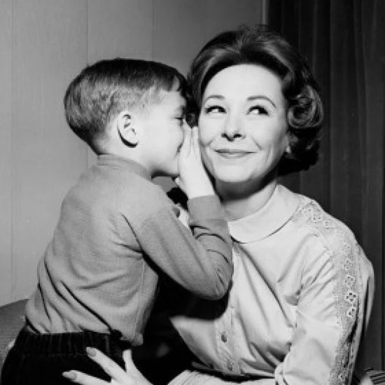 Side profile of a son whispering into his mother's ear Poster Print (18 x 24)