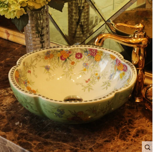

Ceramic art basin on the lavatory basin sink white flower petals green gardens of the basin that wash a face
