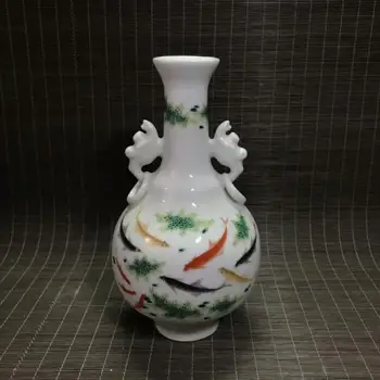 

Porcelain ornaments in retro-home office, fresh pink vases, goldfish, algae and Tule in them