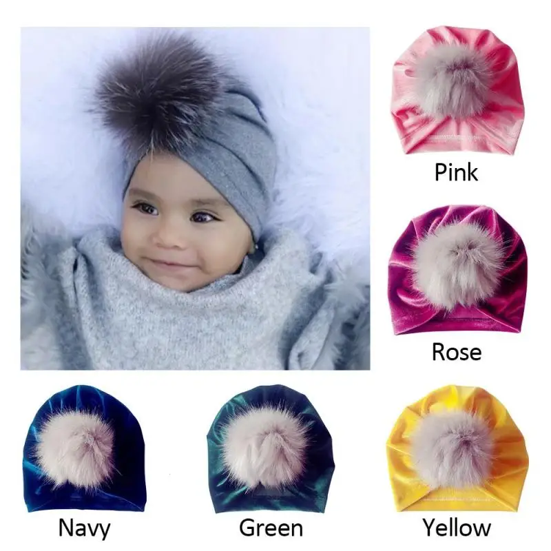 girls navy bobble hat