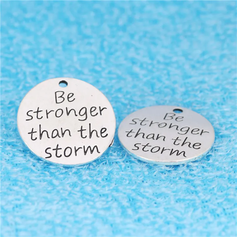 

Newest Style 10 Pieces/Lot Diameter 23mm Antique Silver Plated Be Stronger Than The Storm Message Charms For Jewelry Making