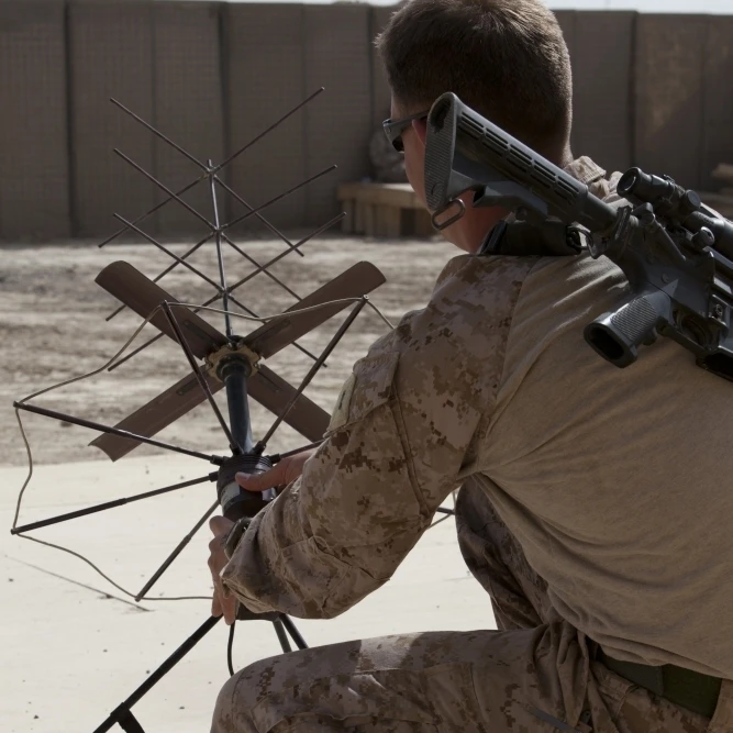 U.S. Marine repositions a satellite communication antenna Poster Print (22 x 34)
