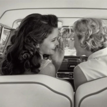 Rear view of two young women talking in car Poster Print (18 x 24)