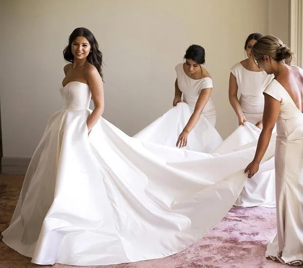 sweetheart-ivory-satin-wedding-dress-with-pockets-sleeveless-long-bridal-dress-with-court-train-classic-corset-wedding-gown-custom-made_