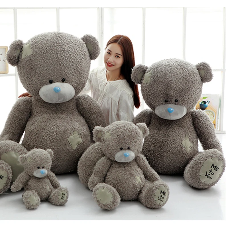 grey teddy bear with patches