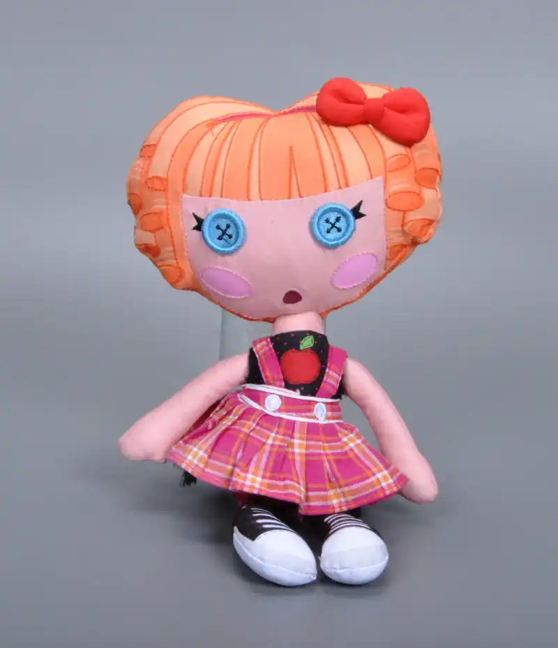 doll with pink hair and button eyes