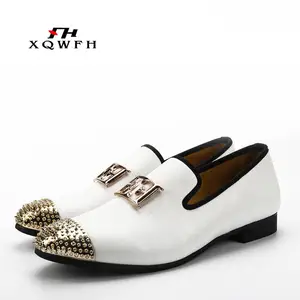 white and gold loafers with spikes
