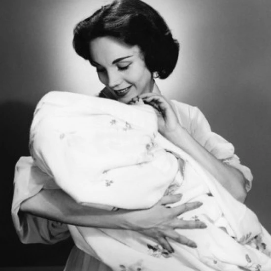 Portrait of mother carrying wrapped baby Poster Print (18 x 24)