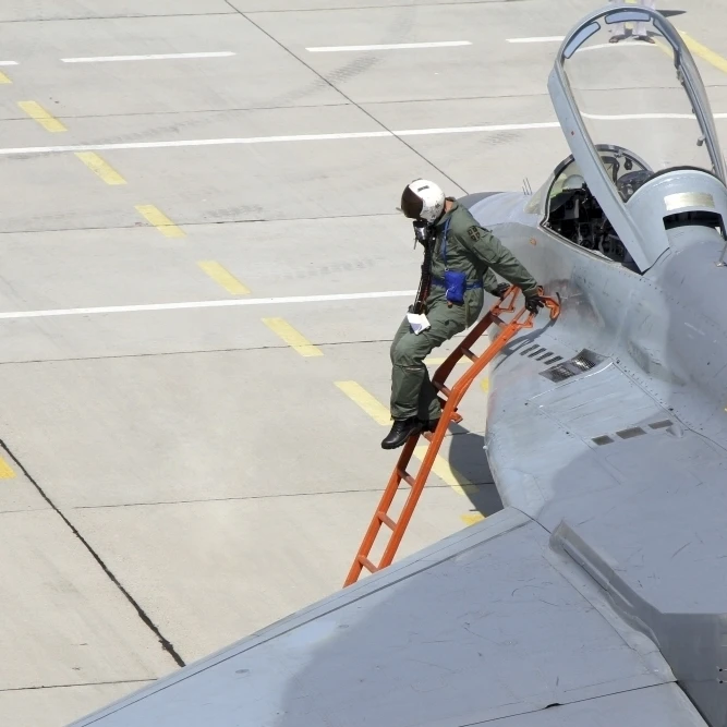 Serbian Air Force pilot climbs down from the cockpit of a MiG-29 Poster Print (17 x 11)