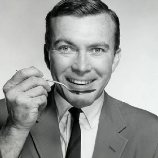 Portrait of a businessman eating with a spoon Poster Print (24 x 36)