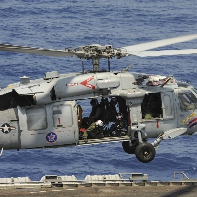 An MH-60S Sea Hawk prepares to land on the flight deck of USS Nimitz Poster Print (17 x 11)
