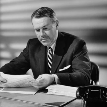 Businessman reading documents in an office Poster Print (18 x 24)