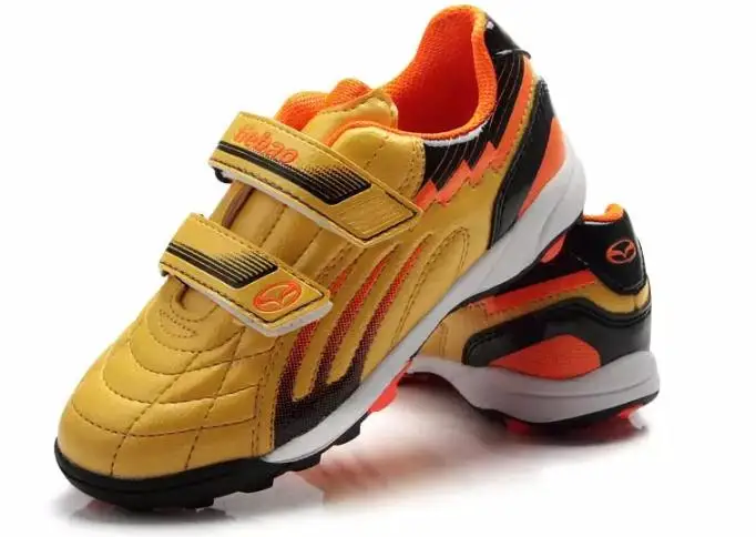 black and gold kids football boots