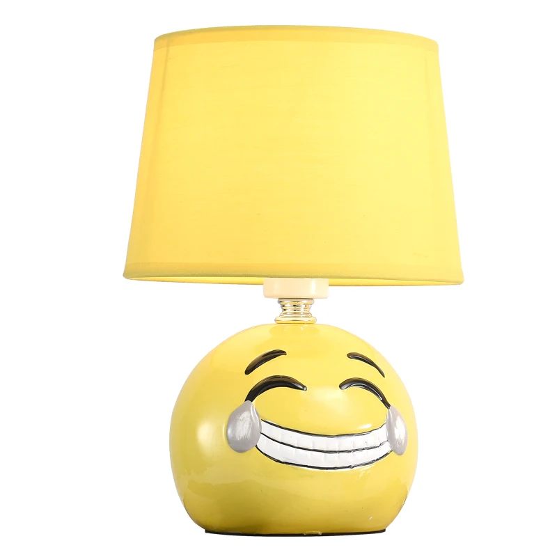

Simple modern bedroom bedside table lamp Nordic American style living room small yellow face expression decorative table lamp