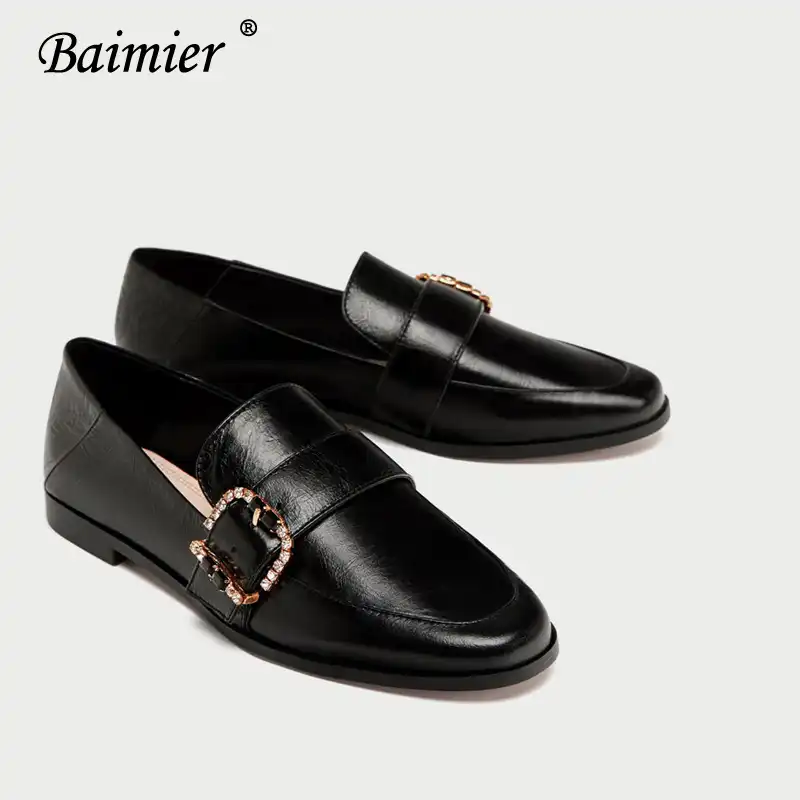 black leather loafers with gold buckle