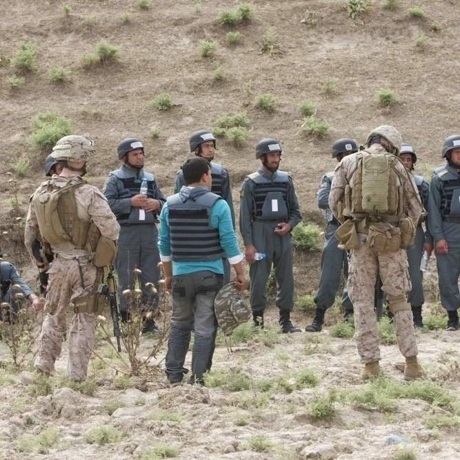 Afghan Police students listen to U.S. Marines give instructions on firing range rules Poster Print (34 x 23)