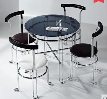 The steel glass small round table. The meeting guest discuss the table and chair combination. A table of four chairs. laura bockno the table of illusion and reality the master s table