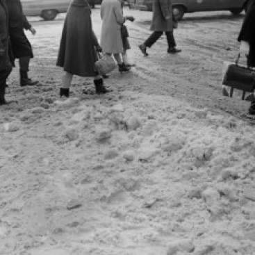 Feet of pedestrians trudging through ice and snow on city street Poster Print (24 x 36)
