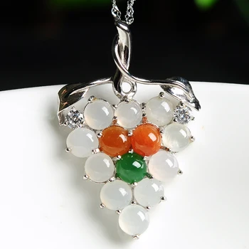 

A cargo ice type emerald egg face inlaid with 925 silver leaf pendant