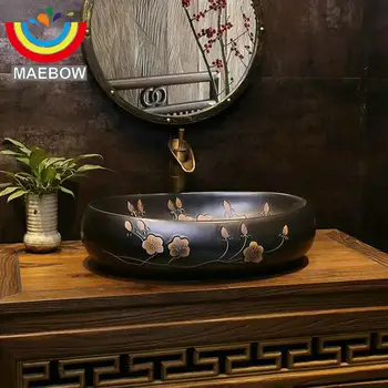 

Vintage Style Engraved Plum Blossom Black Washbasin Oval Basin Ceramic Countertop Bathroom Sink